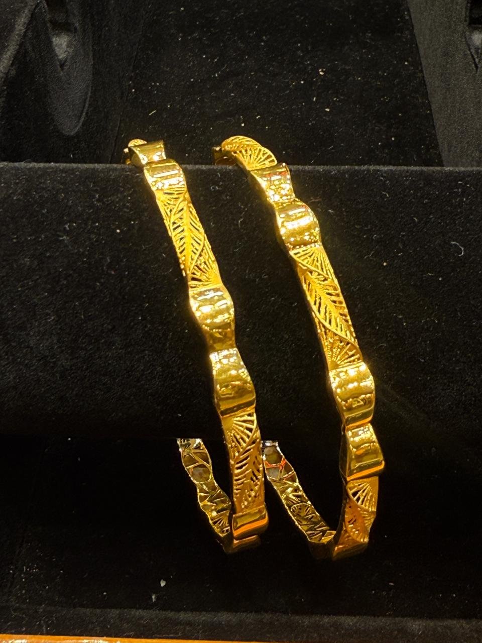 A pair of patterned gold bangles