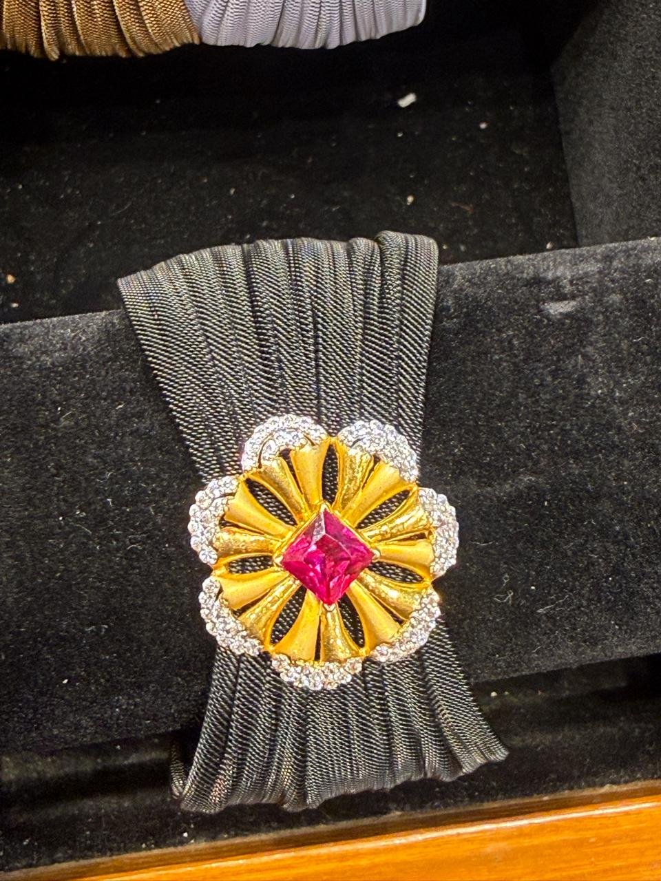 A gold pendant set with a ruby centre and diamond border