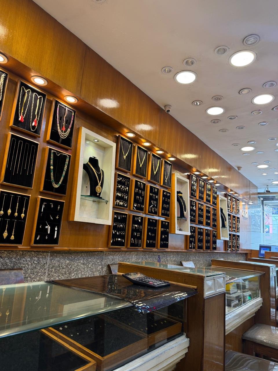 Wall displays of gold jewellery inside the Aina Gold showroom